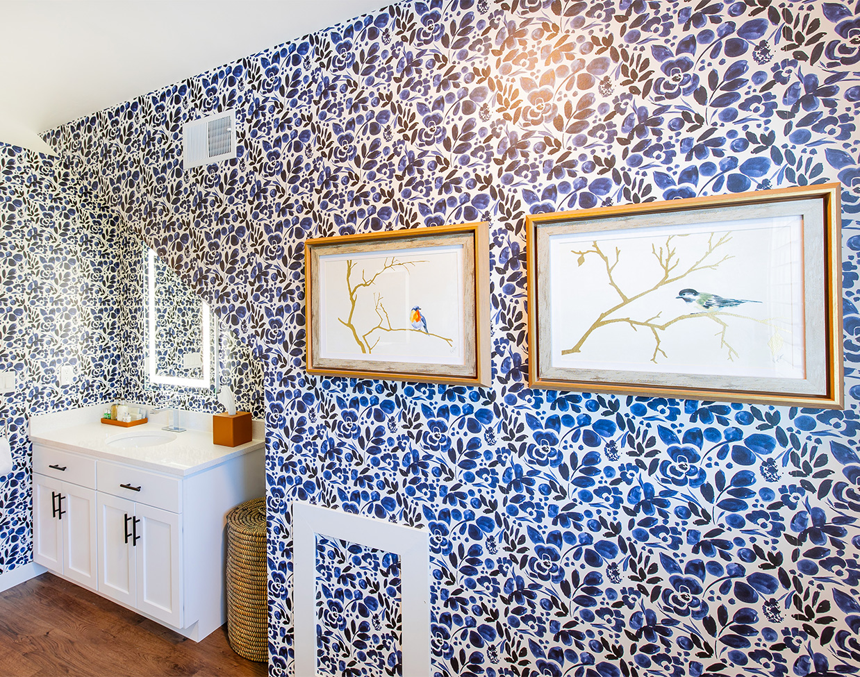 Bathroom with blue floral wallpaper and vanity at The Inn at Stonecliffe, one of the distinctive Mackinac Island hotels.