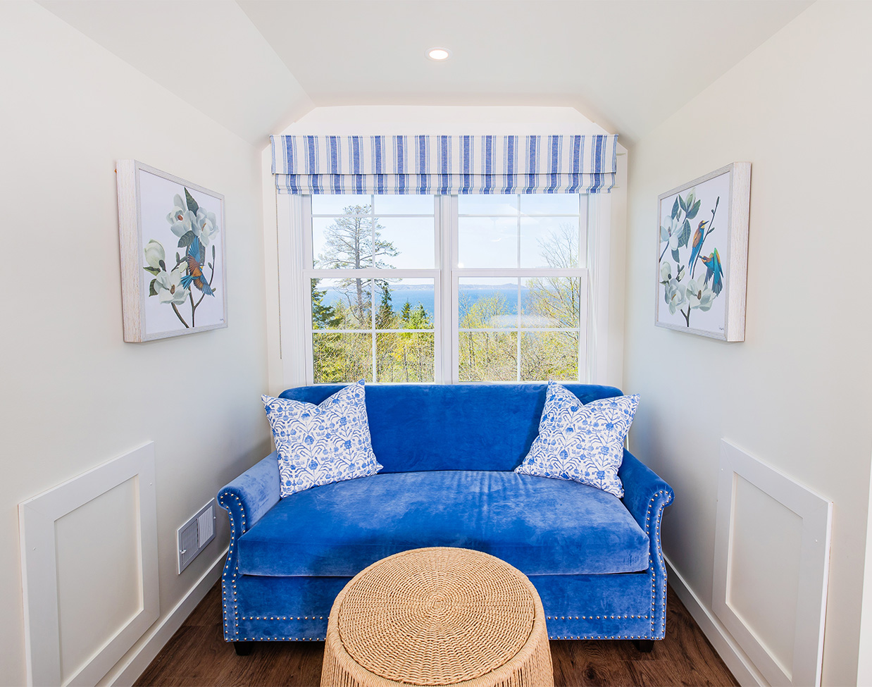 Cozy water-view sitting nook with blue sofa at The Inn at Stonecliffe, one of the scenic Mackinac Island hotels.