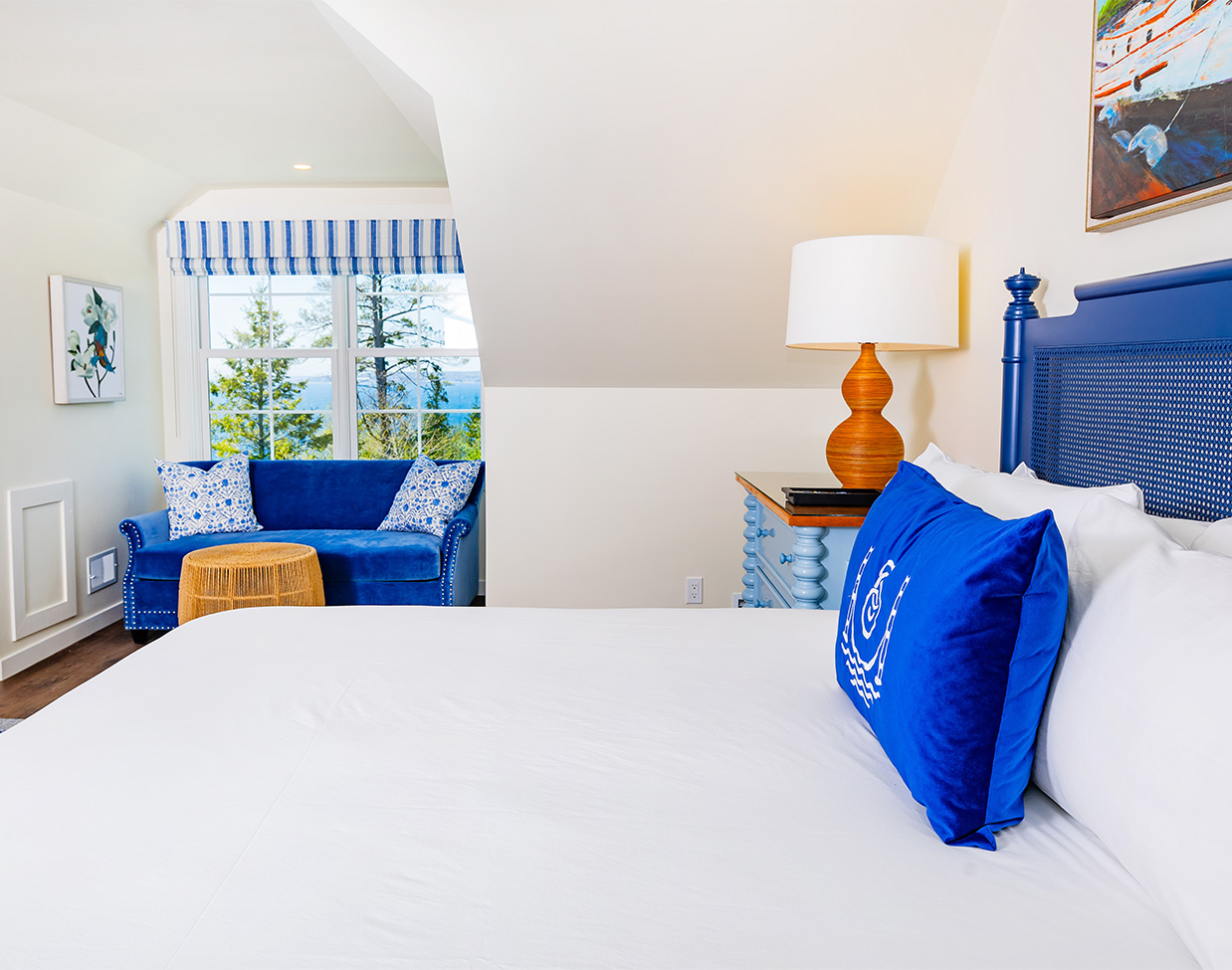 Water-view bedroom suite with blue accents at The Inn at Stonecliffe, one of the scenic Mackinac Island hotels.