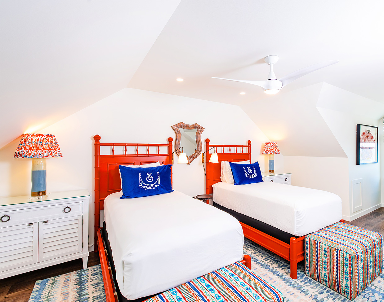 Double queen guest room with red bed frames at The Inn at Stonecliffe, one of the distinctive Mackinac Island hotels.