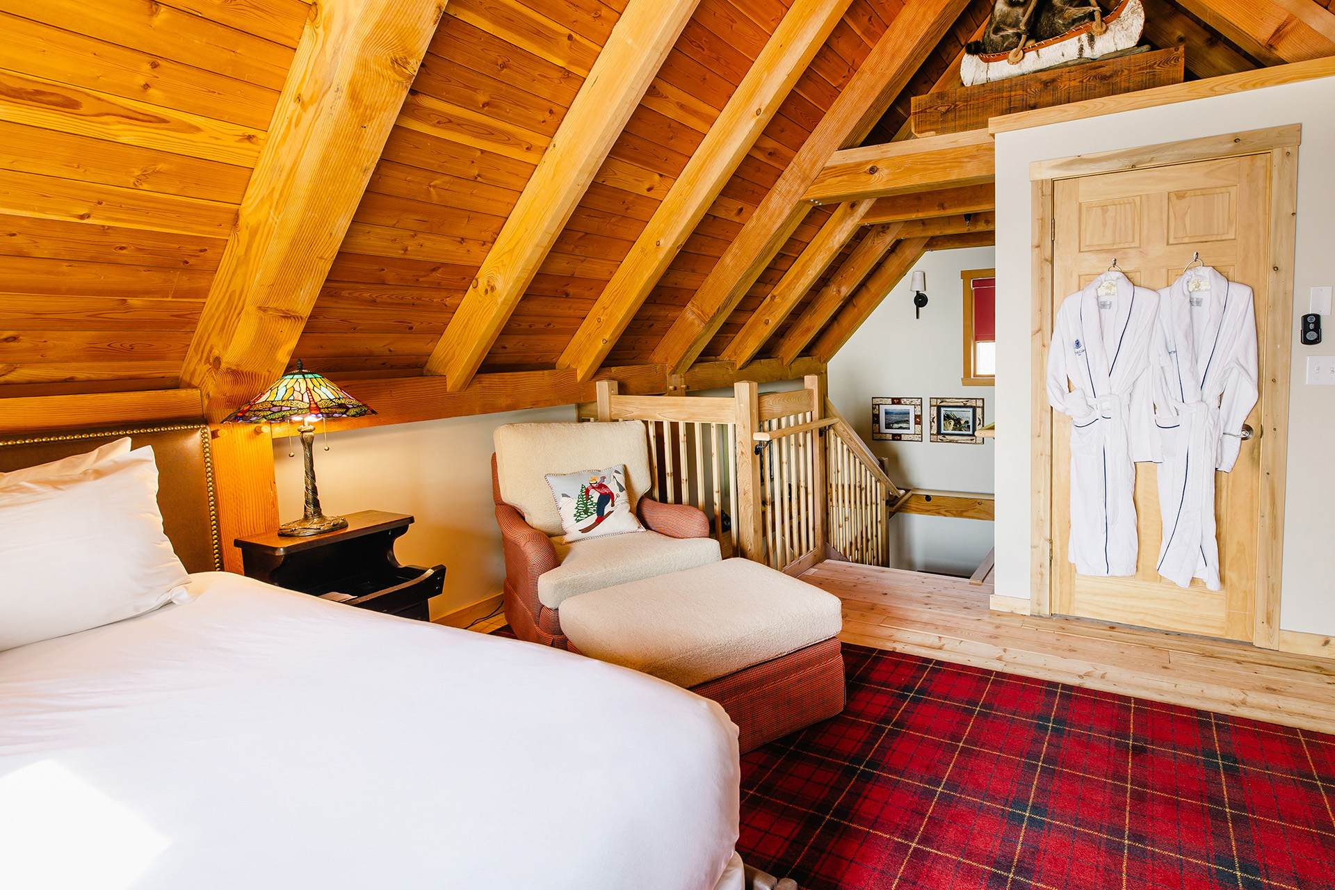 a bedroom with a bed and a red carpet