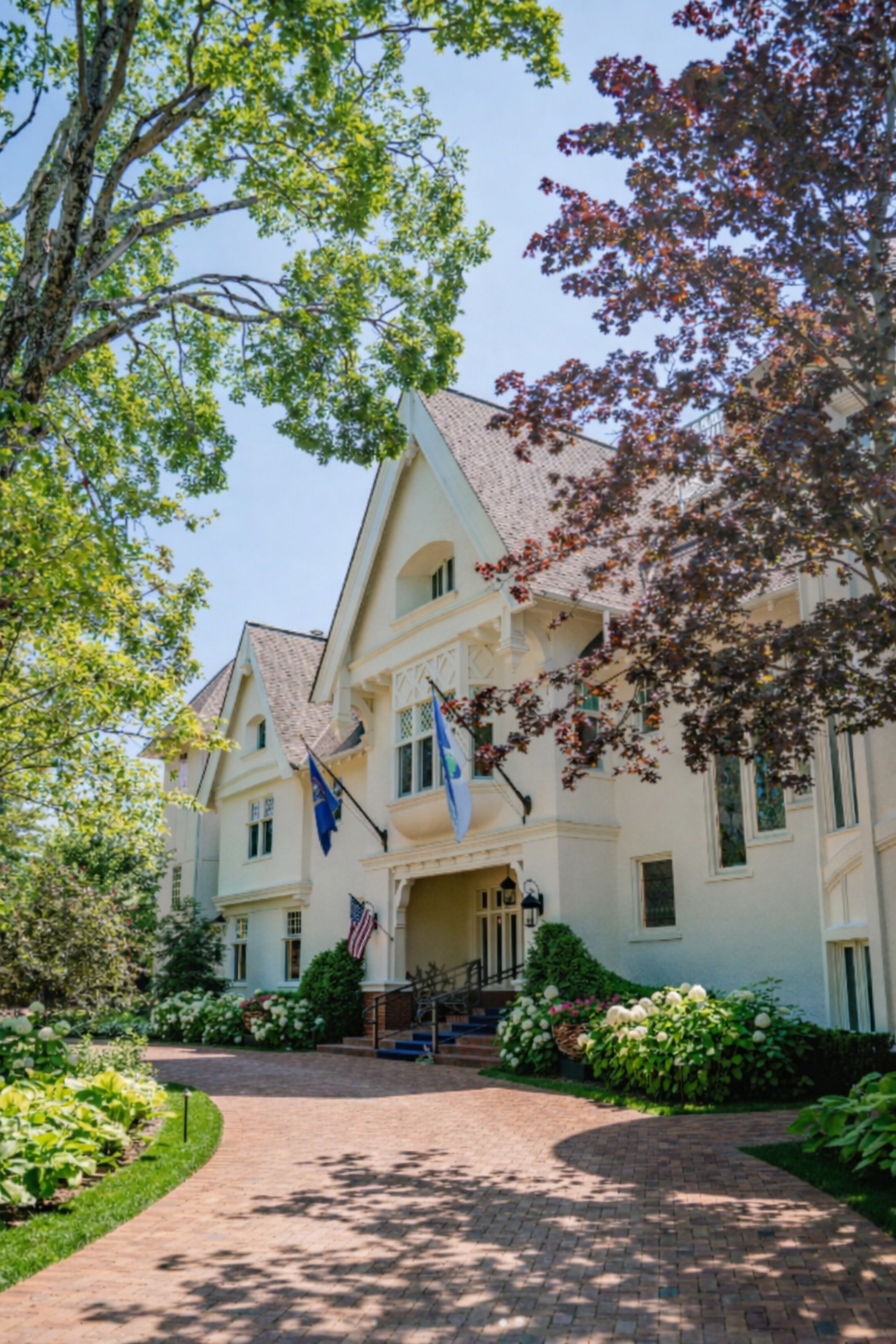 a white house with flags and trees