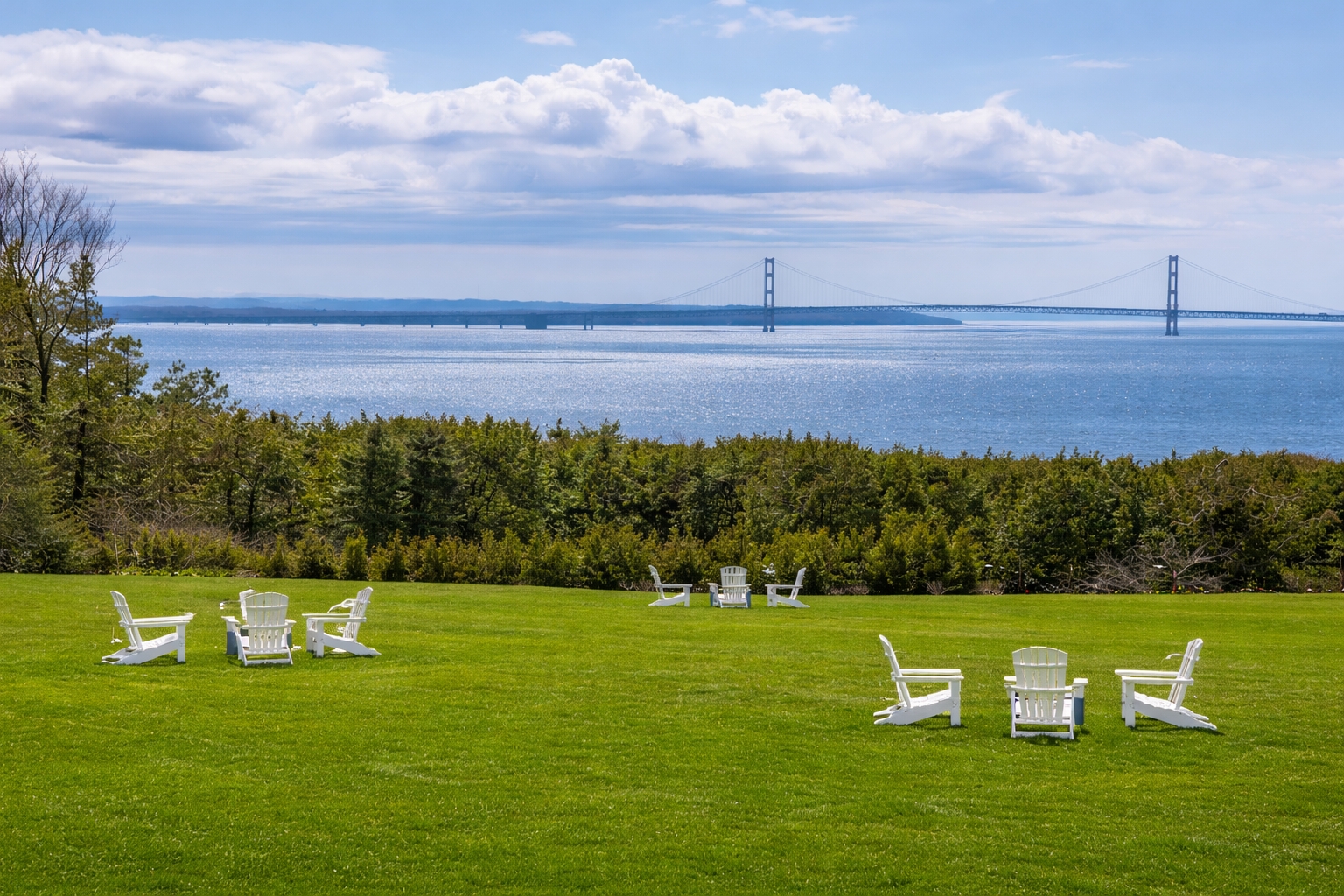 Scenic summer view of Mackinac Island overlooking the Straits of Mackinac and Mackinac Bridge, illustrating one of the best places to go on vacation this summer