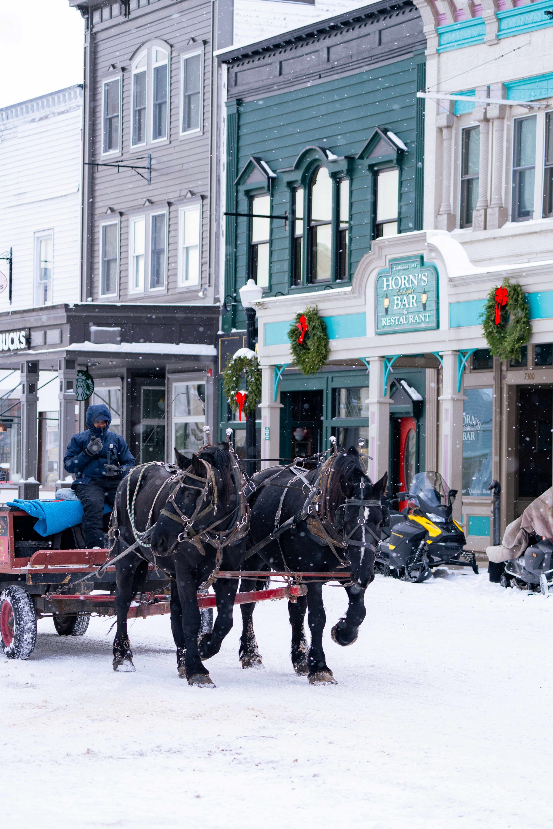 Winter life on Mackinac Island showing snow-covered paths, historic buildings, and frozen Lake Huron during the off-season