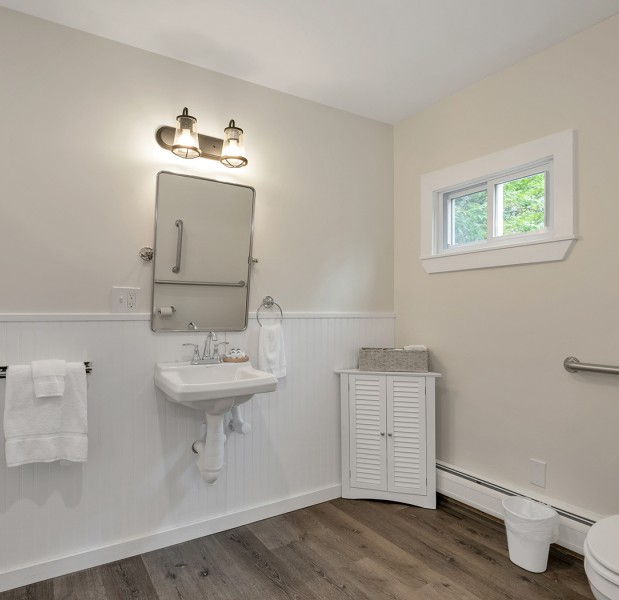 a bathroom with a sink toilet and mirror