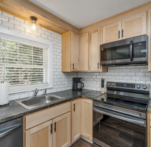 a kitchen with wooden cabinets