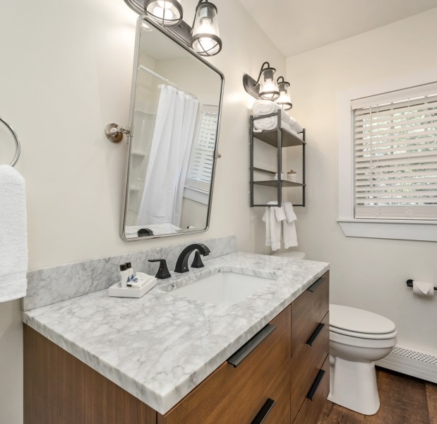 a bathroom with a sink toilet and mirror
