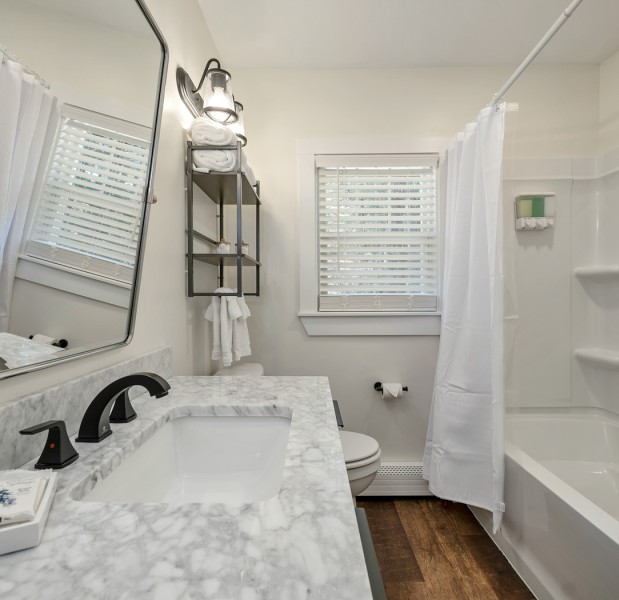 a bathroom with a tub sink and toilet