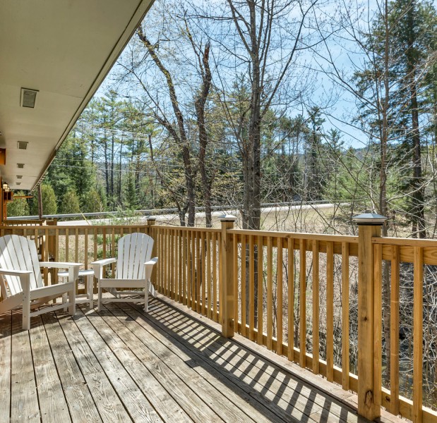 a deck with chairs and a table on it