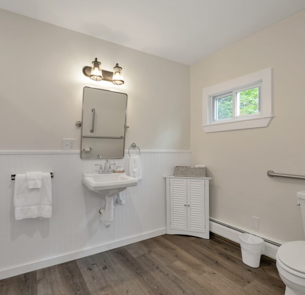 a bathroom with a sink toilet and a mirror