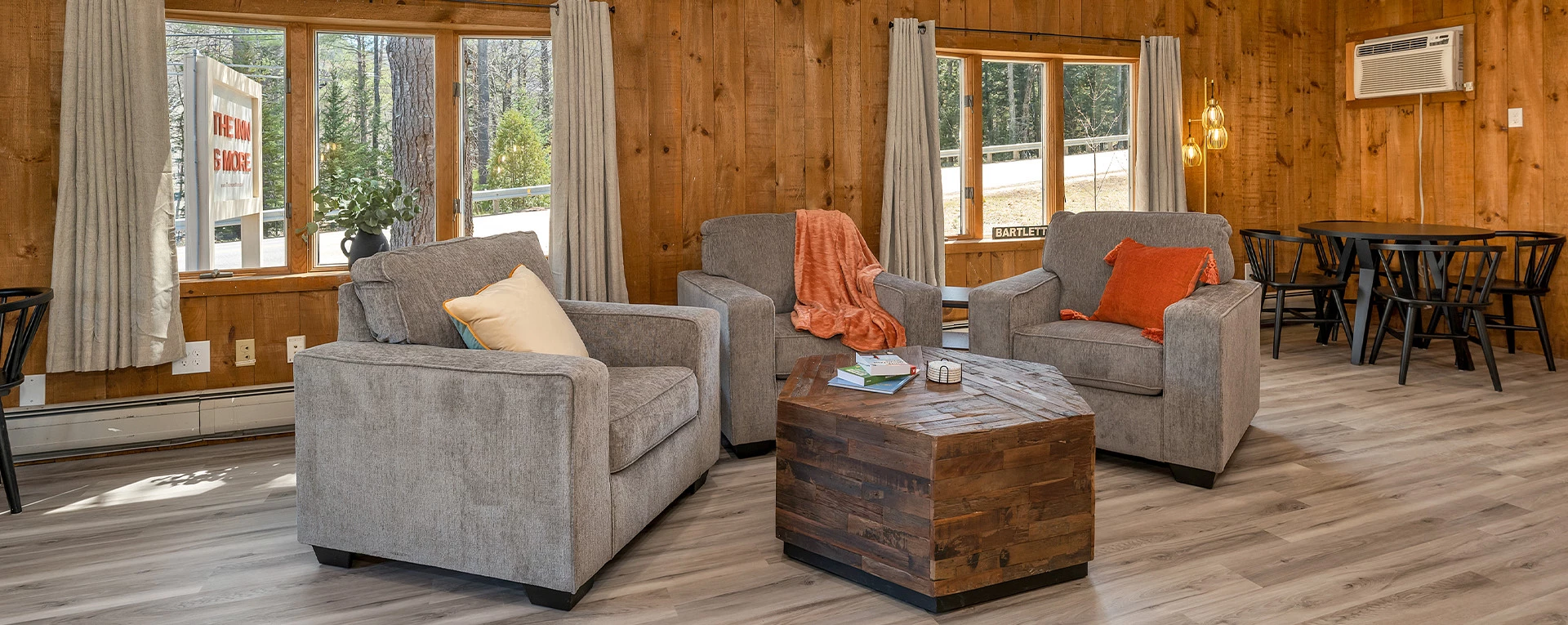 a living room with a couch and chairs