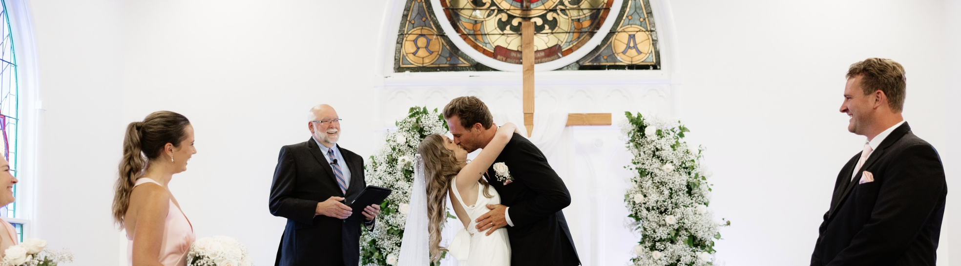 a man and woman kissing in a church