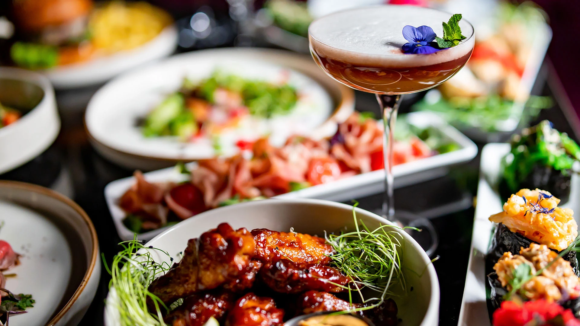 a glass of liquid next to a plate of food