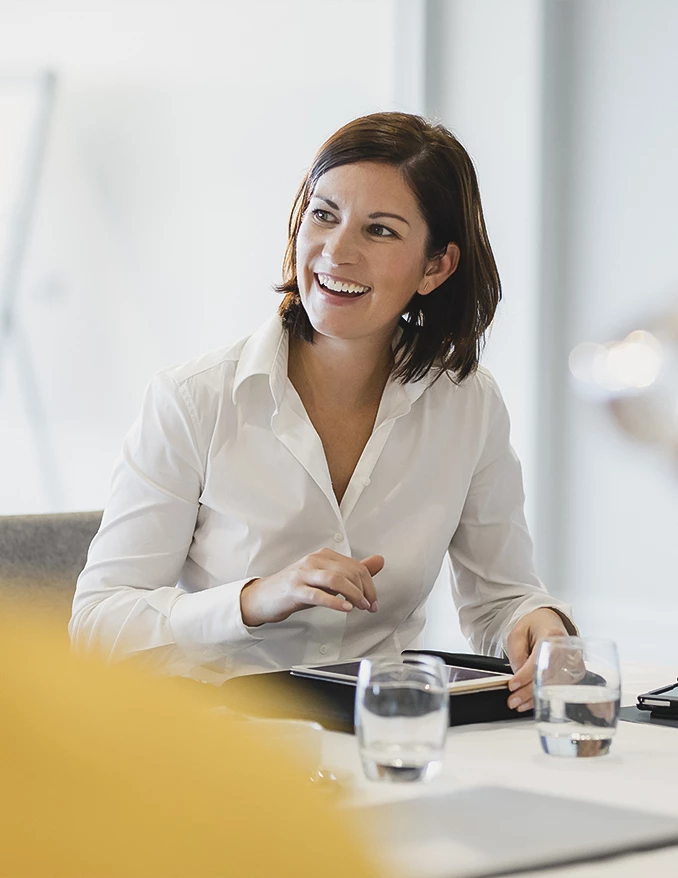 a woman smiling at a table