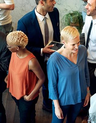 a group of people standing around each other