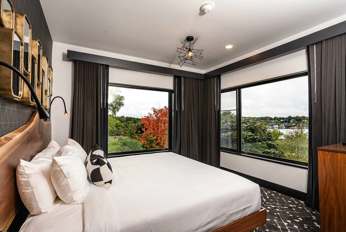 a bedroom with a bed and windows