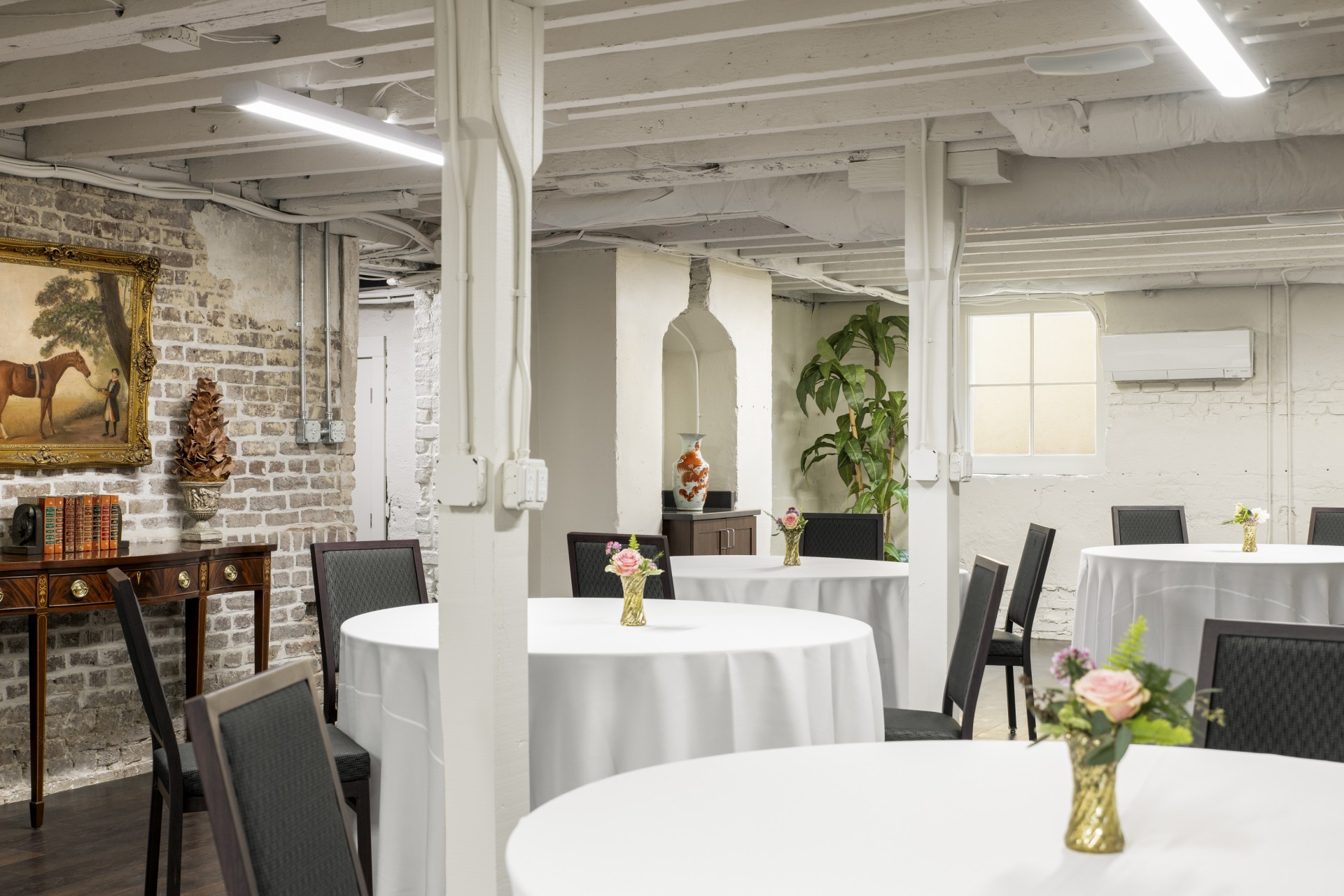 a room with white tables and chairs