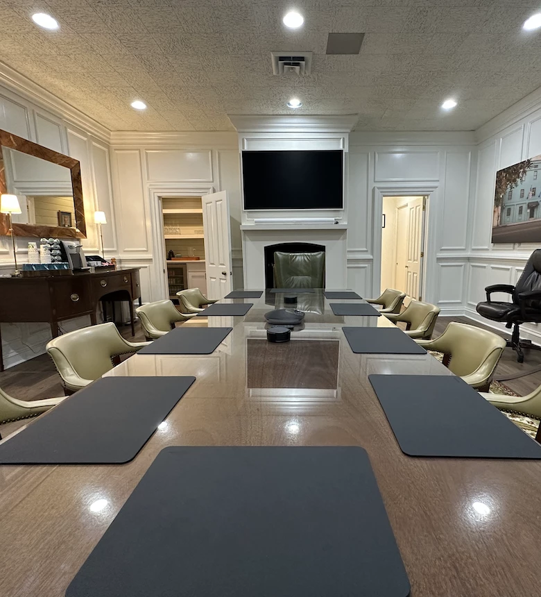 a conference room with a large table and chairs