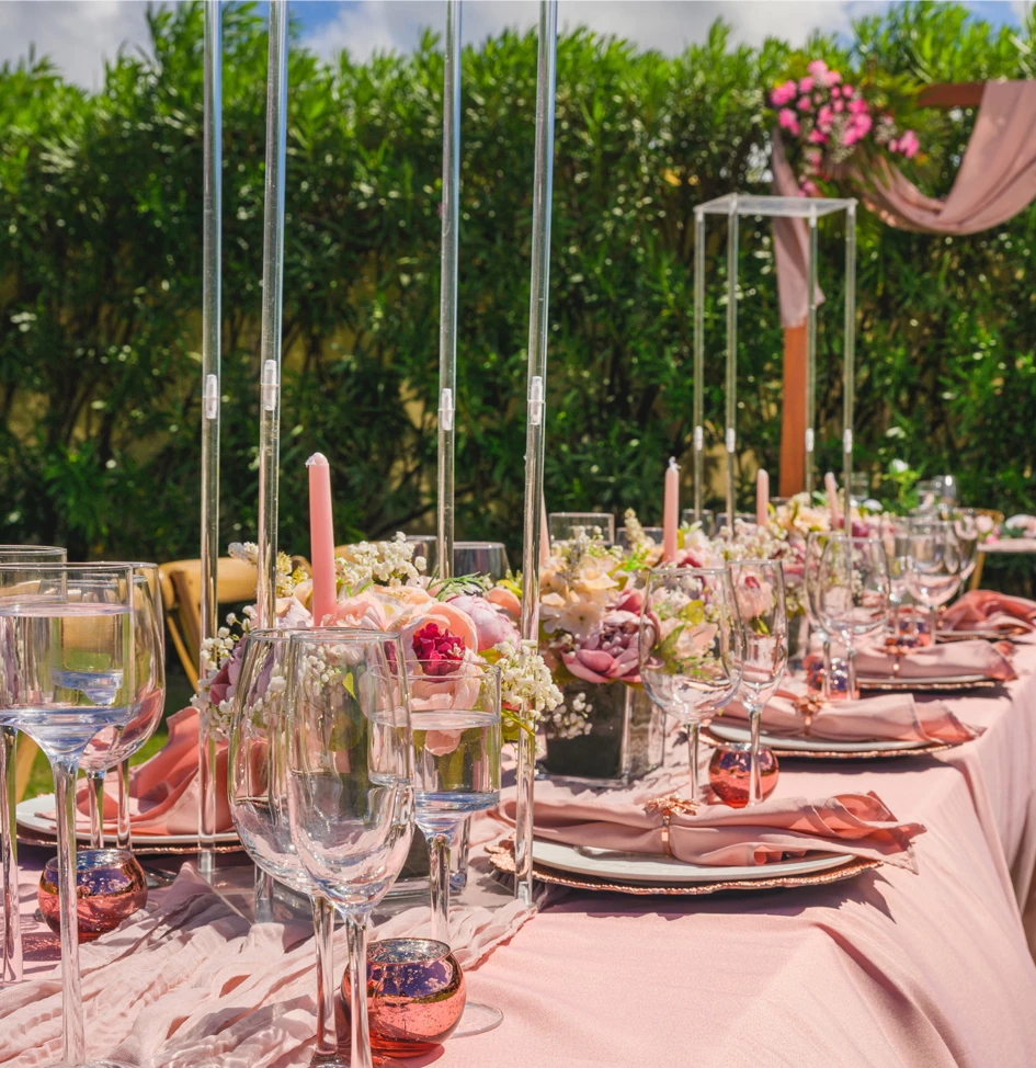 a set of tables with glasses and plates on it