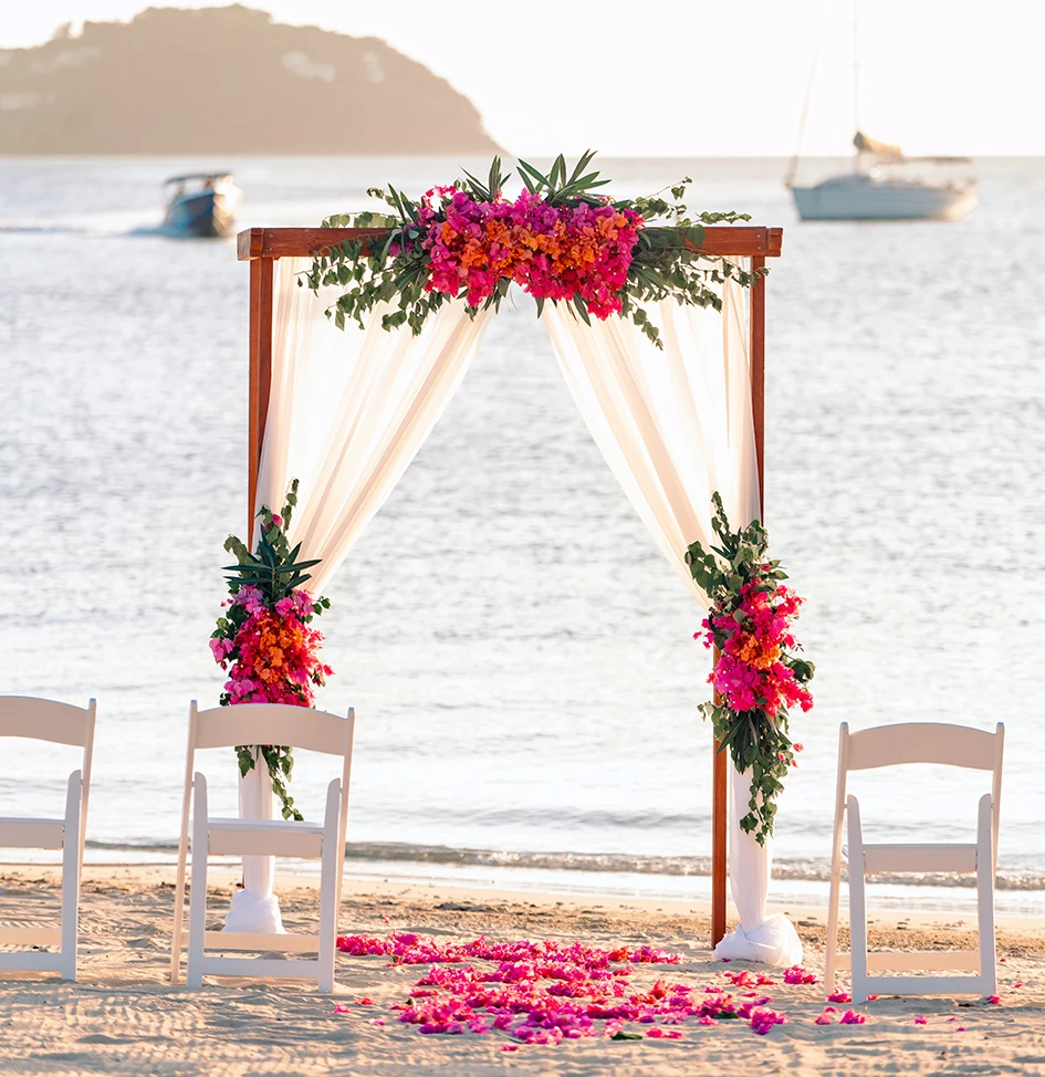 an alter with florals on the beach