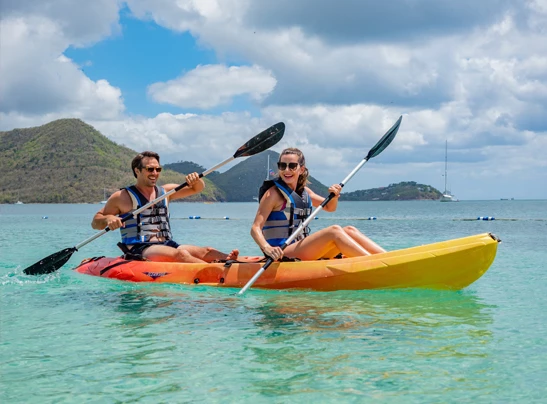 a couple of men in a canoe