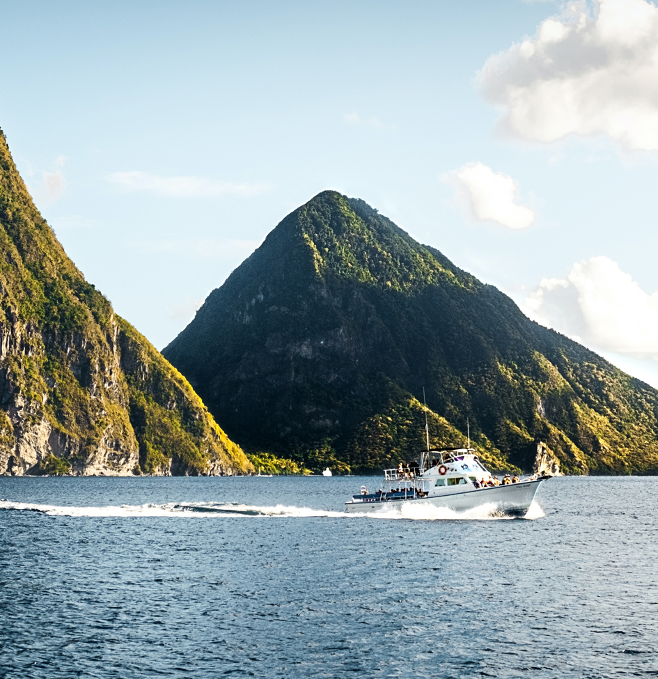 a boat in the water with mountains in the background