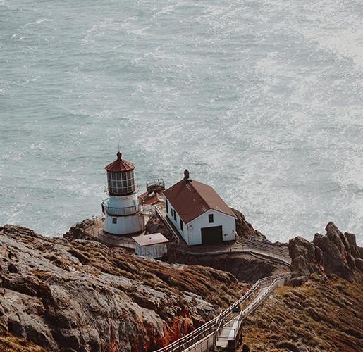 old look out building on a cliff near the ocean