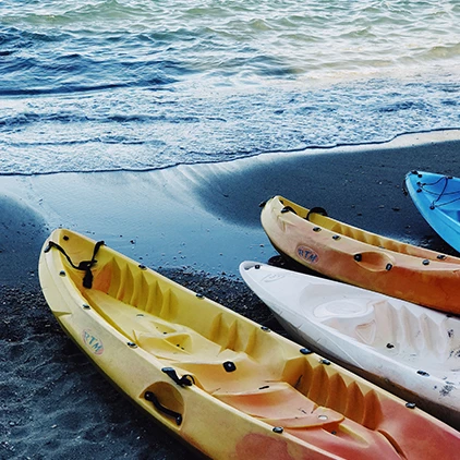 three kayaks lined up at the shoreline