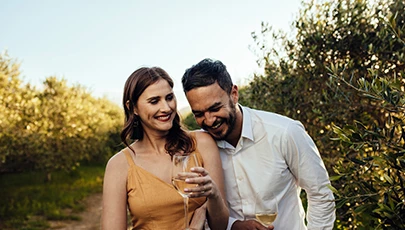 couple laughing and sipping wine