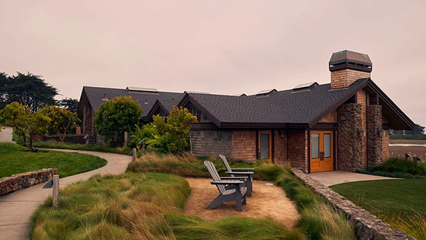 a building with a lawn and chairs