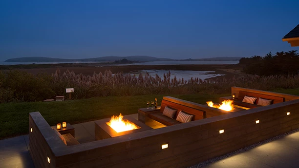 a fire pit with a lake in the background