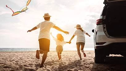 a family running on the beach