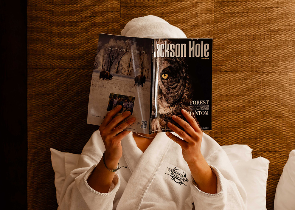 a person in a white robe reading a book