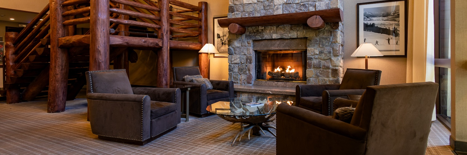 a room with a fireplace and couches