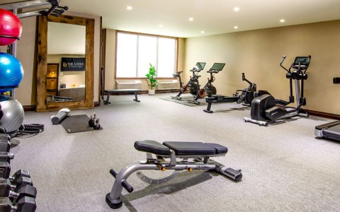 a room with exercise equipment and exercise bikes