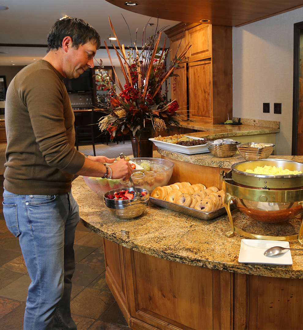 a man standing in front of a buffet table
