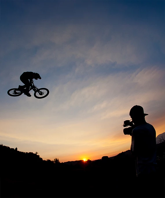 a man taking a picture of a man on a bicycle