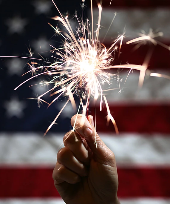 a hand holding a sparkler