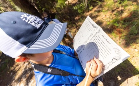 child writing in book