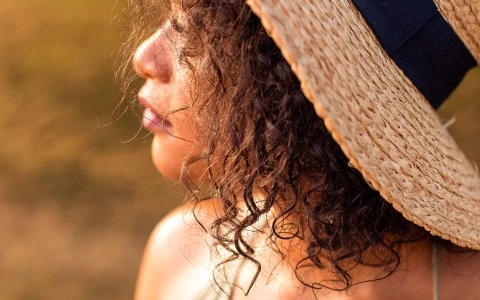 side view of woman with a hat on 
