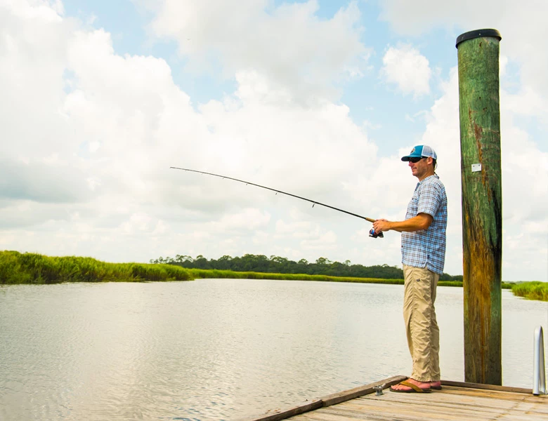 man fishing alone on dock