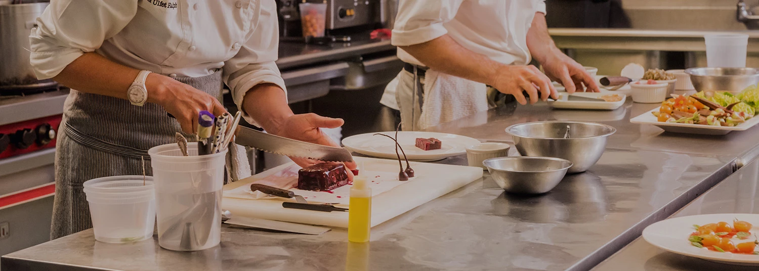 two chefs preparing food 