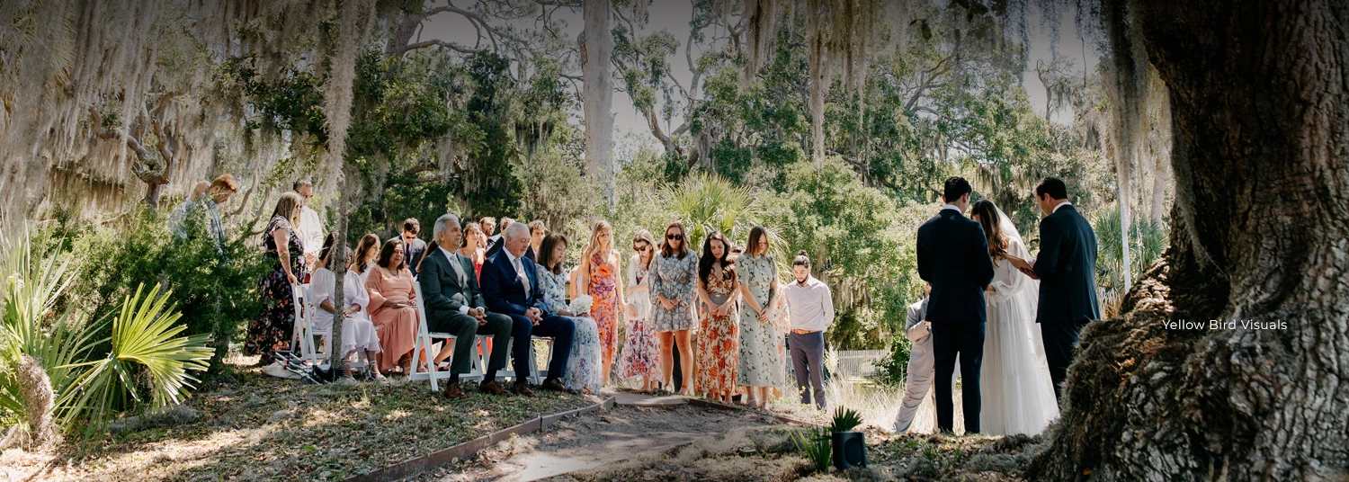couple getting married underneath oak trees