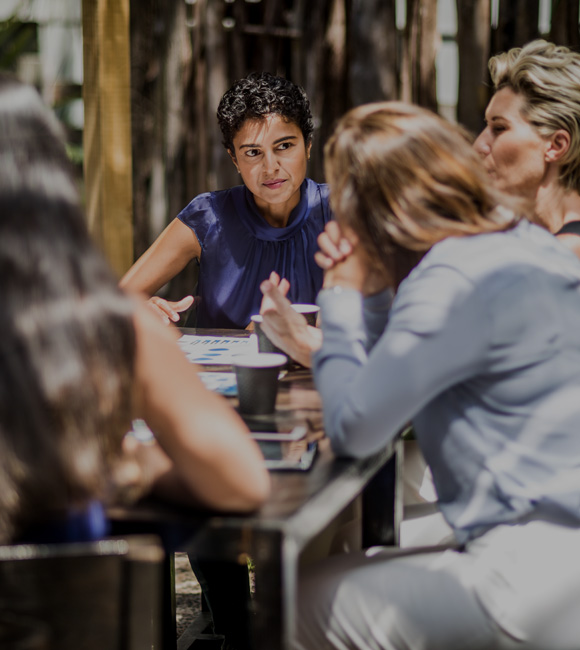 group of people meeting and talking at a table