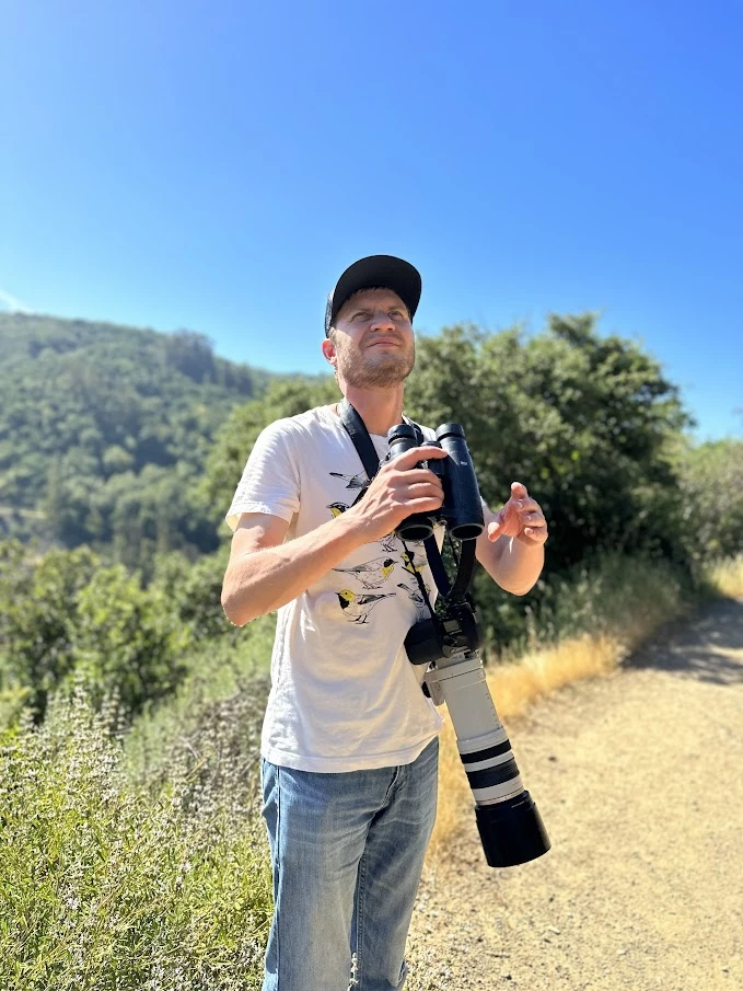 a man holding a large binoculars