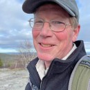 a man wearing a hat and glasses