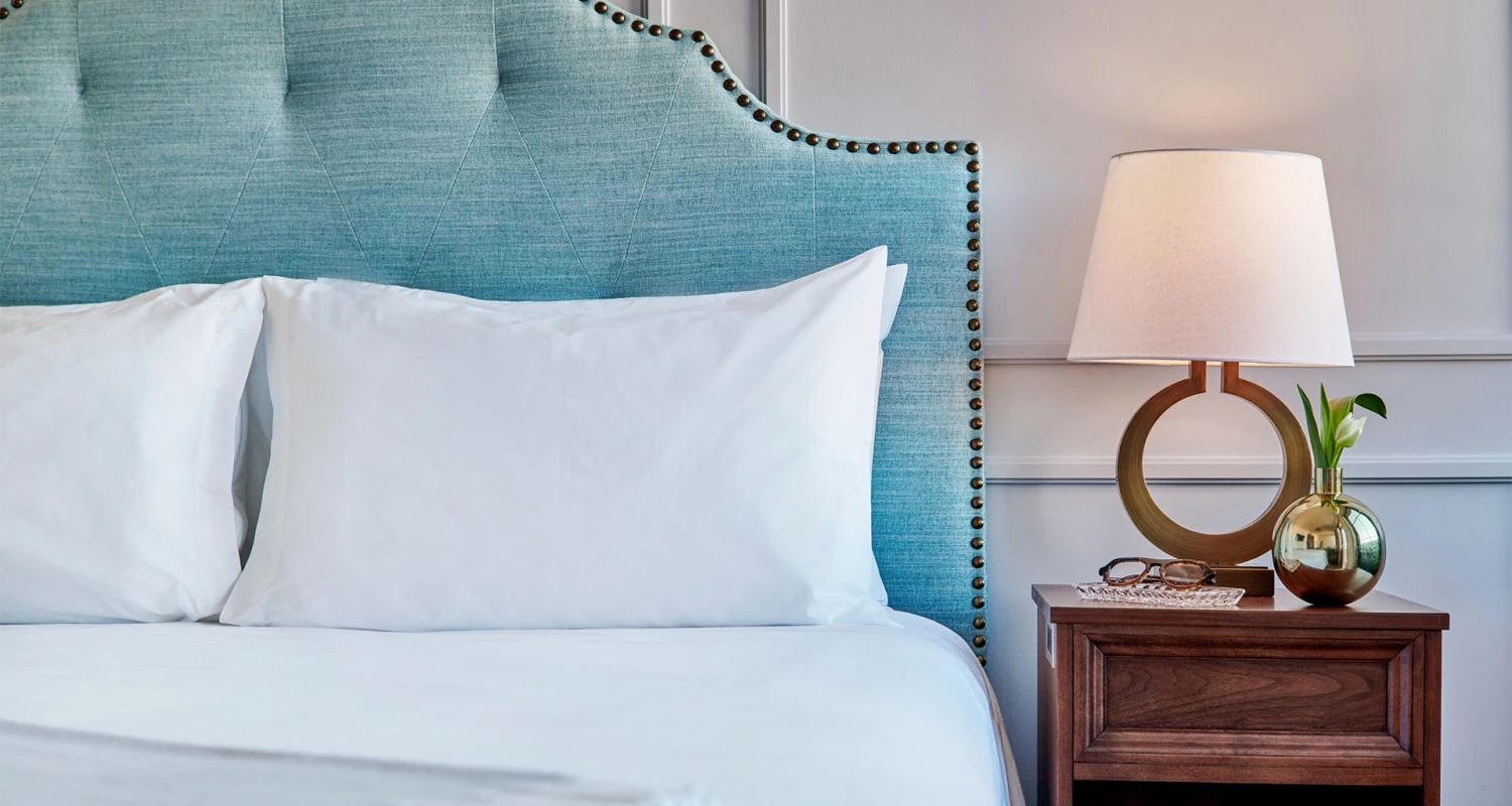 a bed with a lamp on a nightstand