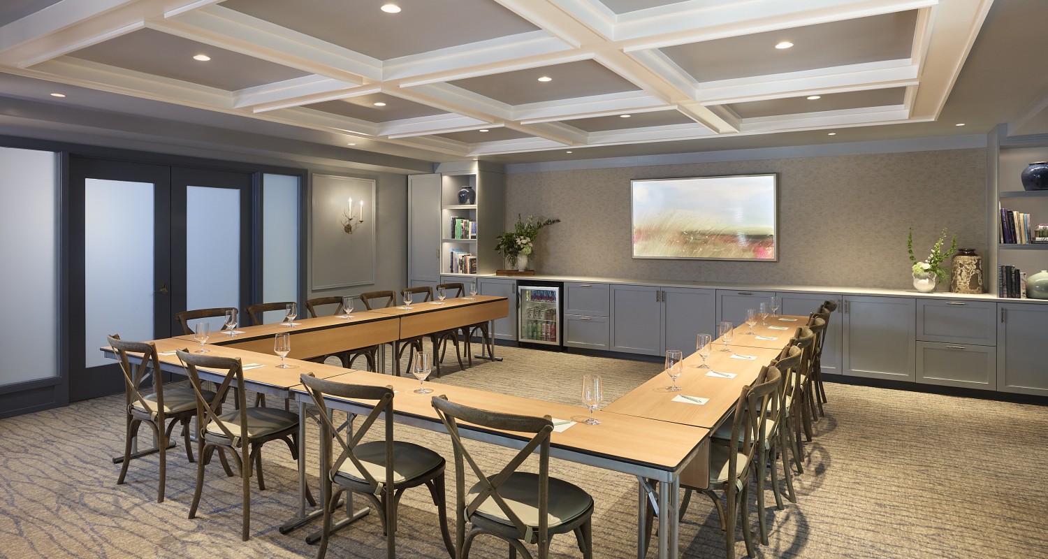 a room with a long table and chairs
