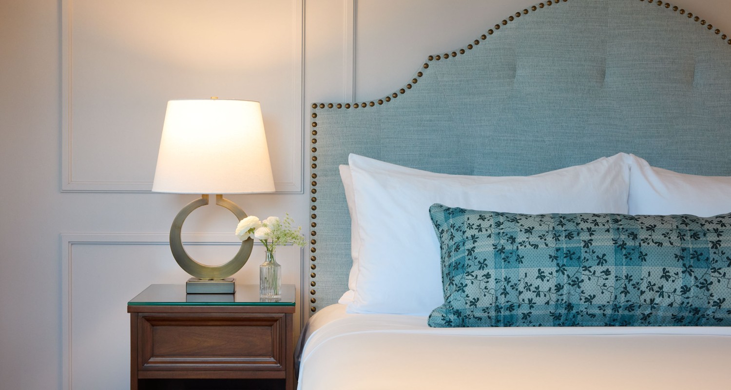 a bed with a lamp and a table