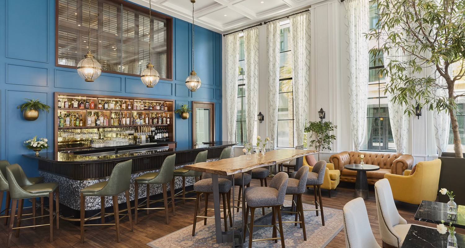 a room with a bar and chairs